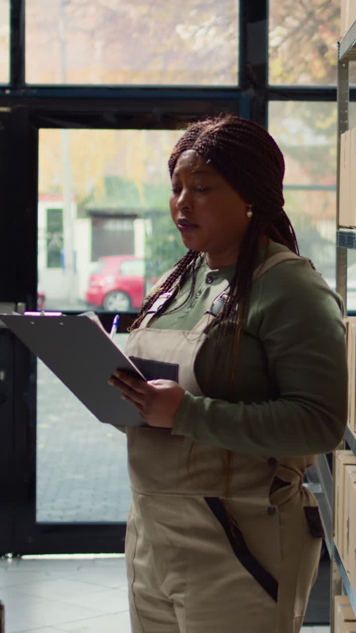 Vertical video Director reviews warehouse inventory