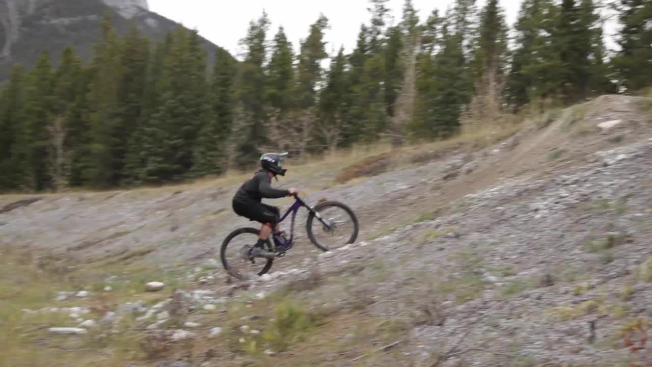 Biker jumps pass in the forest