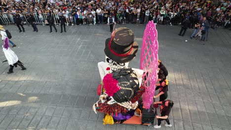 day of the dead parade with skeleton floats and costumed participants