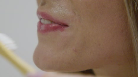 a woman brushing teeth, close up