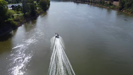 speedboat cruising on cumberland river at daytime in usa - aerial drone shot