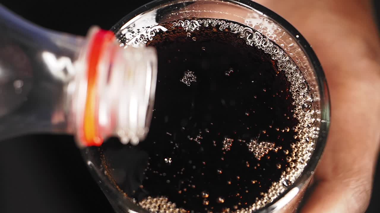 Versare la soda in un bicchiere