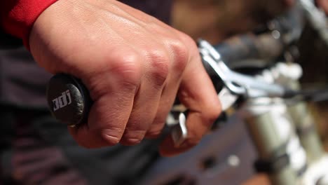 closeup of biker gripping brakes