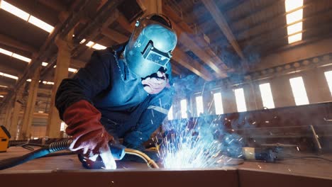 Factory-Worker-is-Welding-in-Protective-Helmets-and-Glasses,-slow-motion,4K