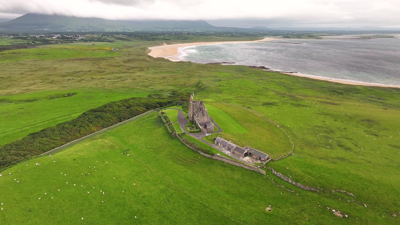 Remote Mullaghmore Castle on Sligo coastal, green landscape with beach and seascape. Ireland