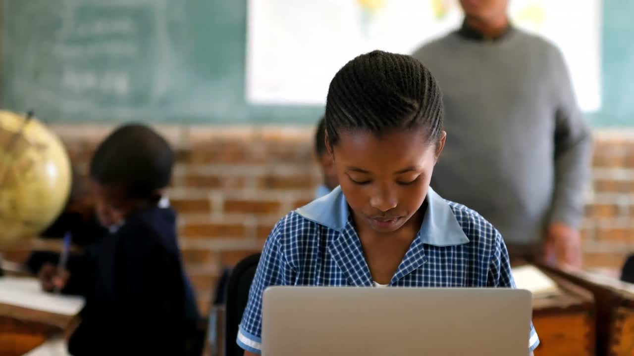 Schoolkid using laptop in the classroom 4k