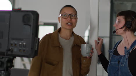 two women having a conversation in a studio