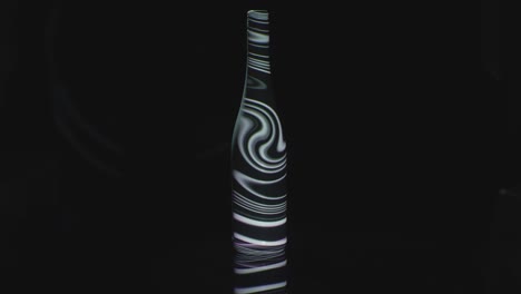 a bottle with swirls projected on it