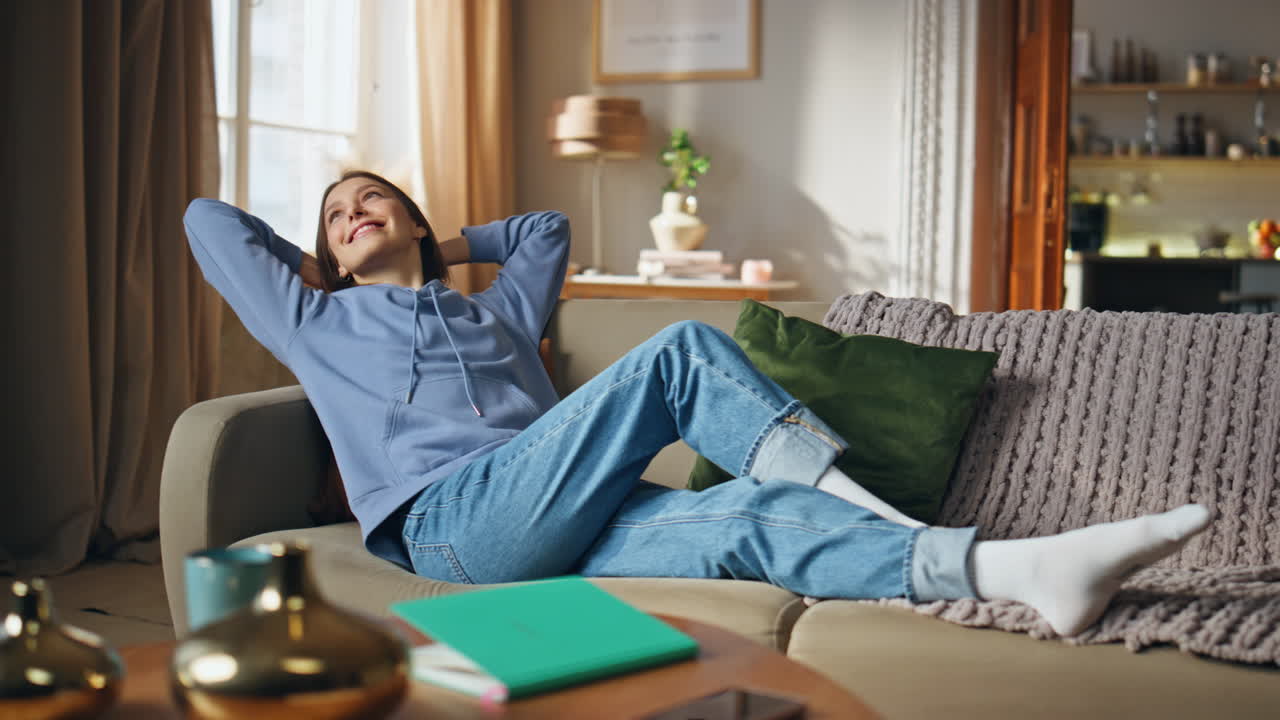 Woman relaxing on couch in living room