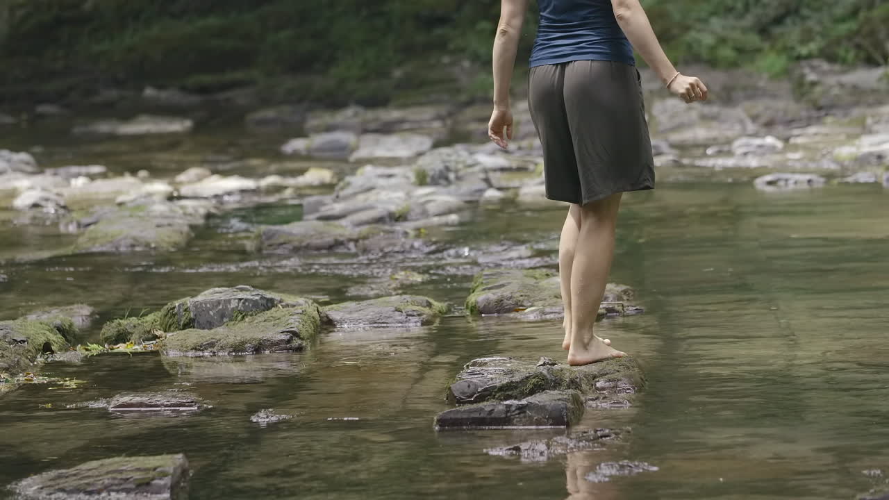 Woman walking through a shallow river
