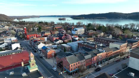 panoramic drone view of downtown columbia, pennsylvania at sunset with reflections off many of the buildings along the riverbank