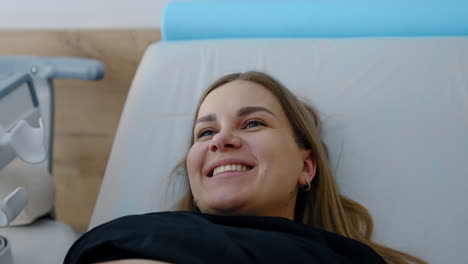 happy pregnant woman during ultrasound procedure