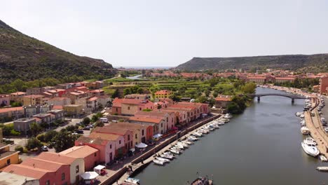 Static-establishing-view-of-Bosa-river-Temo,-colorful-Sardinian-houses,-Italy