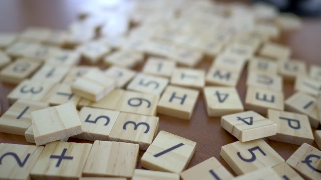 Creative gameplay with letter tiles on a wooden table in a close-up artistic arrangement