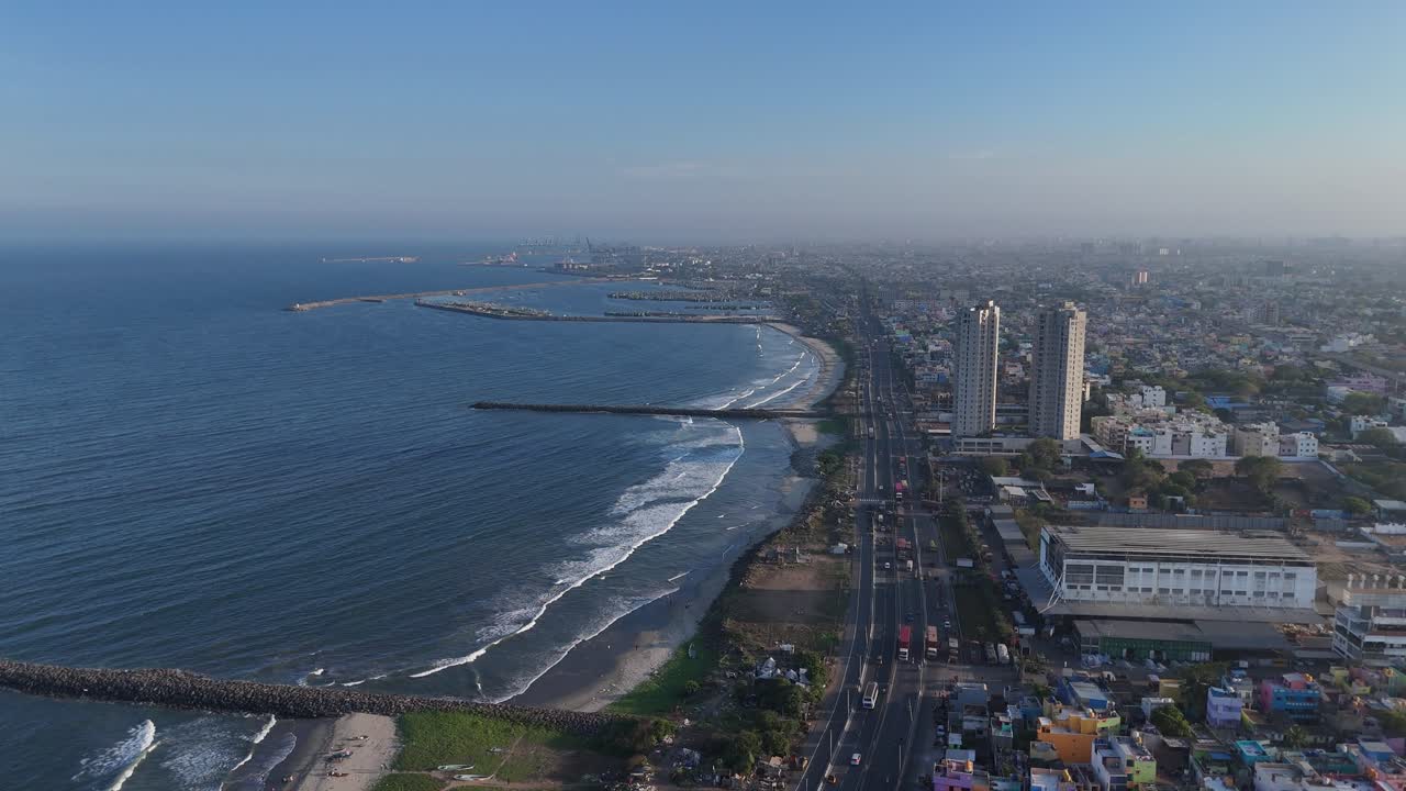 Drone shot over congested residential rooftops in North Chennai during golden hour