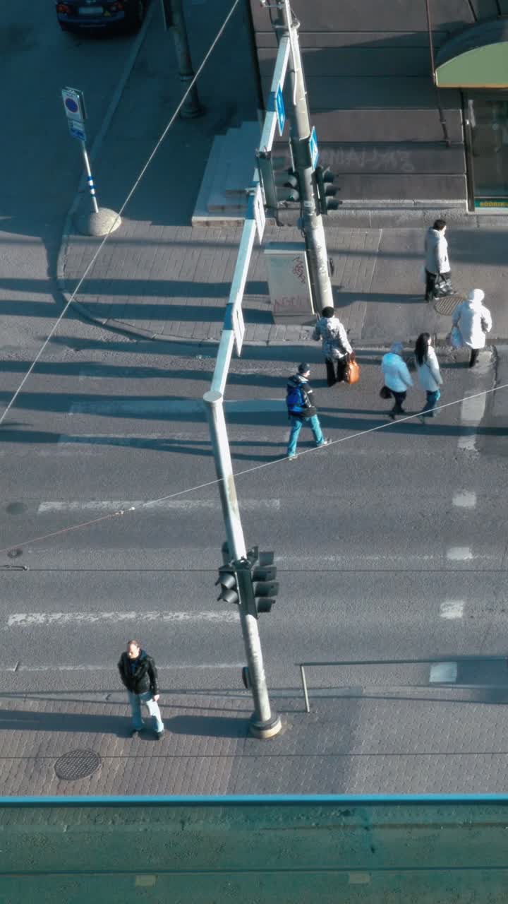 City street scene with pedestrians crossing the road