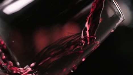 Pouring-Red-wine-into-Glass-in-Slow-motion,-Extreme-Close-up-shot