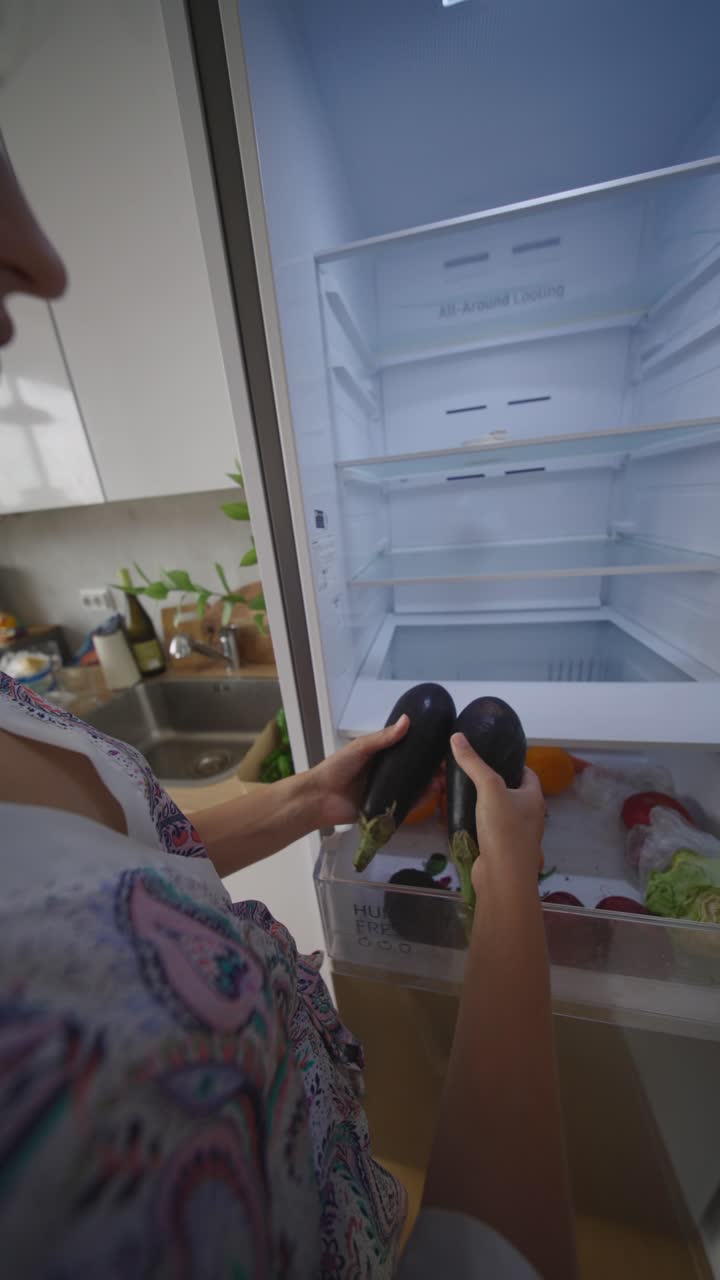Person Putting Vegetables and Fruits into Refrigerator
