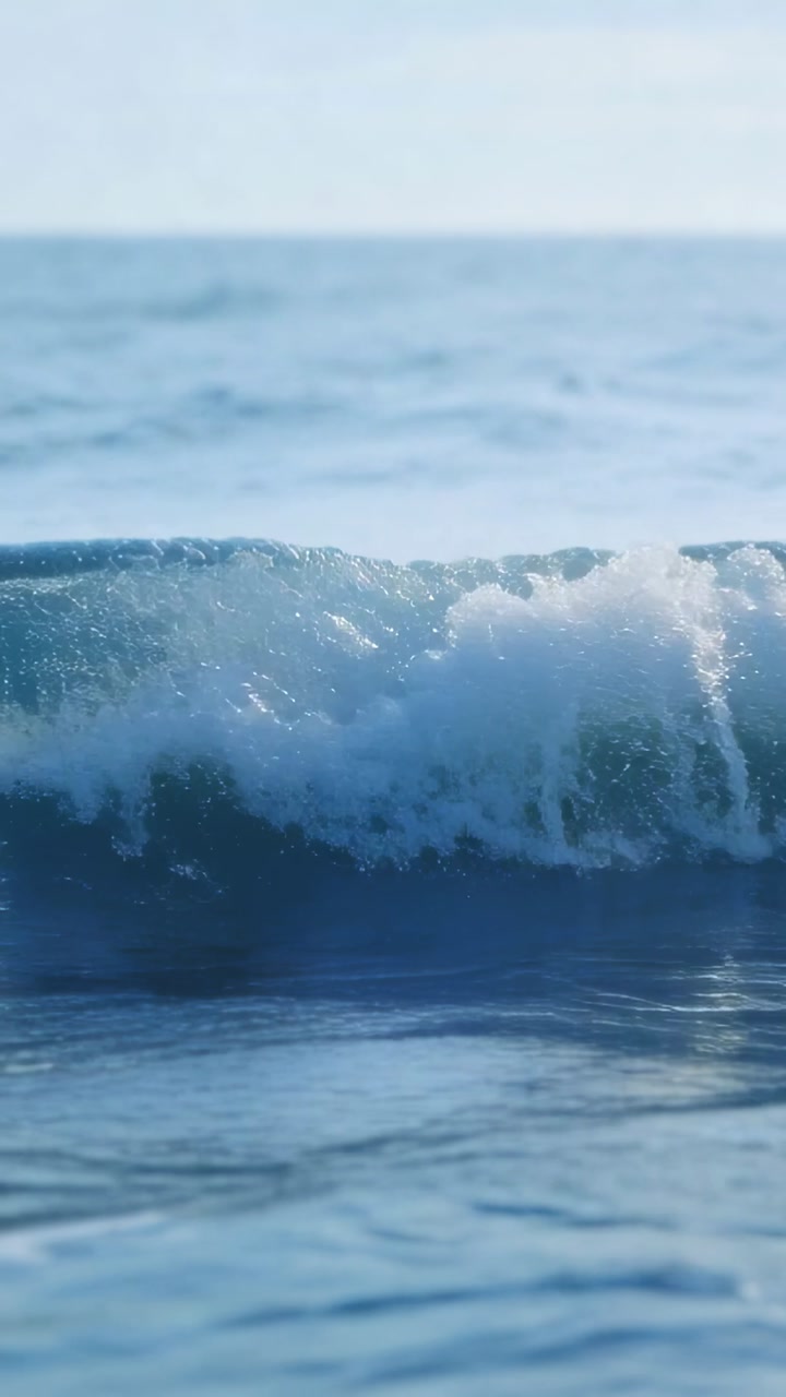 Vertical video: Swell rising wave crest curling and breaking foam moving to near lens for research