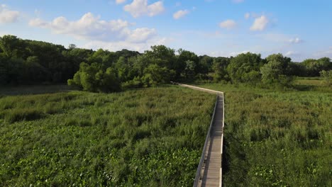 aerial showing wooden walking path made between lush greenery at old cedar avenue, bloomington minnesota