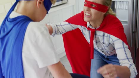 Mother-in-superhero-costume-tying-sons-shoe-laces-4k