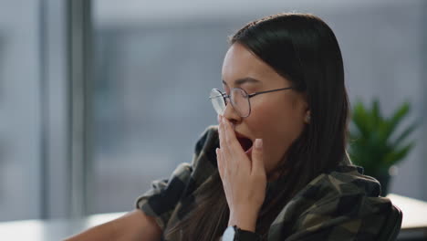 sleepy woman yawning at remote workplace portrait. exhausted student learning
