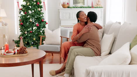 Couple,-love-and-christmas-celebration-in-a-living