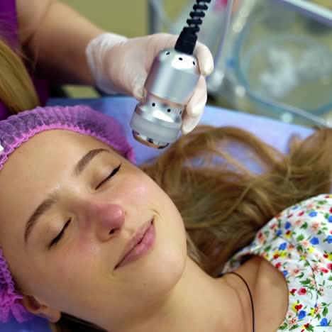 a professional cosmetologist makes facial procedures in a beauty salon. cosmetological innovations. modern technic