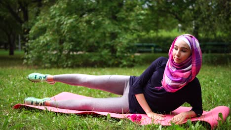 young muslim woman exercising in park