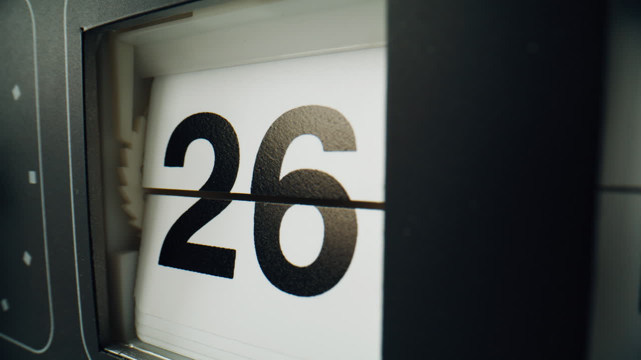 Clock calendar changing panels indoors. Electromechanical watch showing date