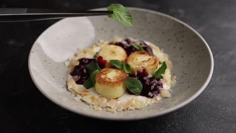 syrniki with cherry sauce and yogurt