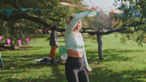 group of friends enjoying a picnic and hooping in a park