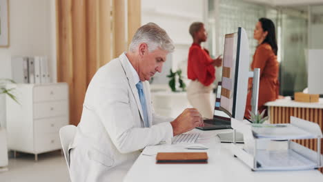 senior man, thinking and working on computer