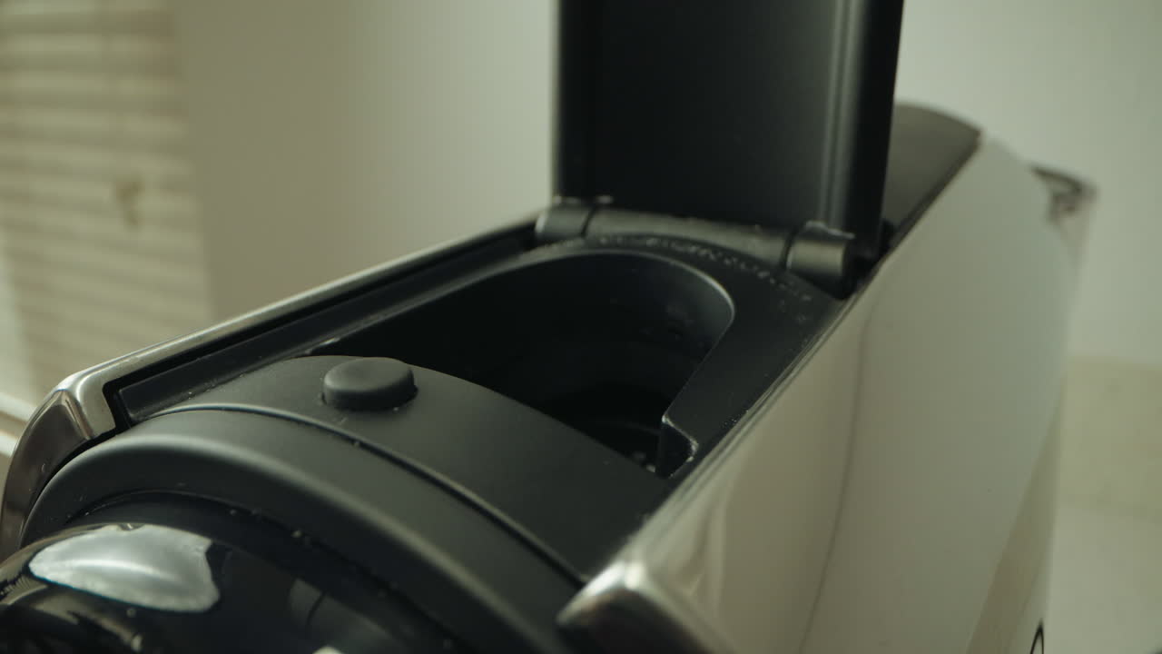 Inserting capsule into a coffee machine, focusing on the action and the machine's mechanism