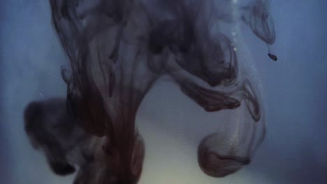 paint floating in water looking like majestic nebulas. stable shot with the sony a7iii.