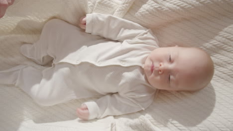 baby lying on a white blanket