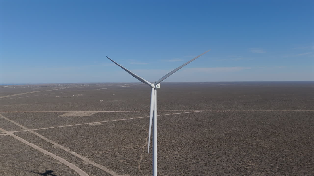 Aerial View of a Wind Turbine in a Desert Landscape