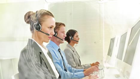 Animation-of-network-of-connections-over-office-workers-wearing-headsets