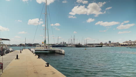 dock with catamaran in the port of valencia, spain on a sunny summer day