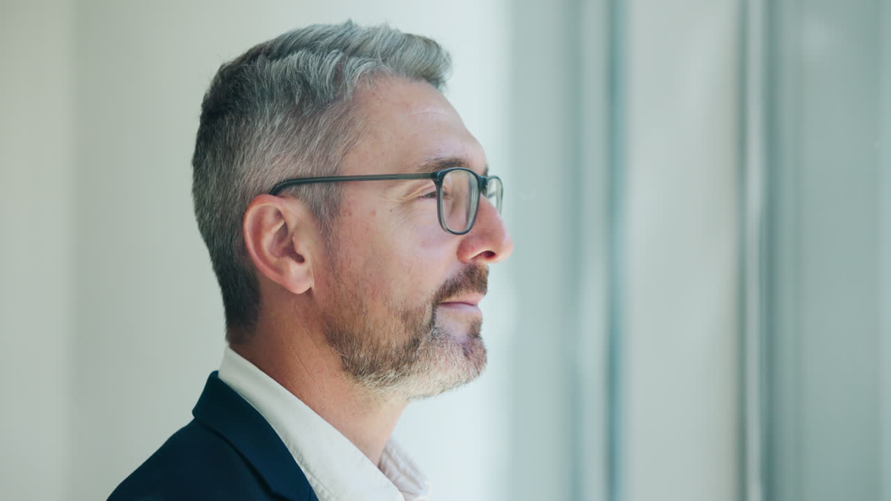 Thoughtful Mature Businessman Looking Up in Profile