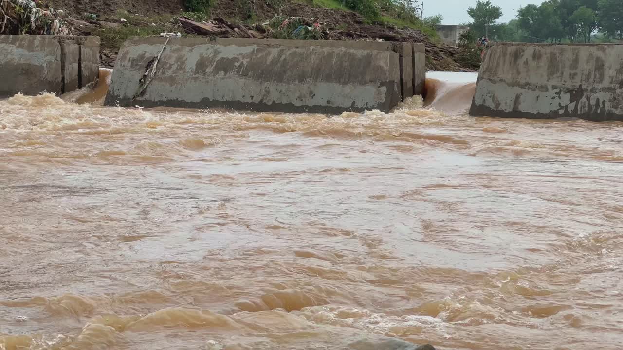 Static shot of a concrete structures for the flood control measures, a dam, levee, or floodwall designed to manage or contain the high volume of water