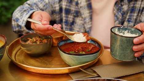 woman eating indian food