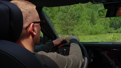 man driving through scenic countryside