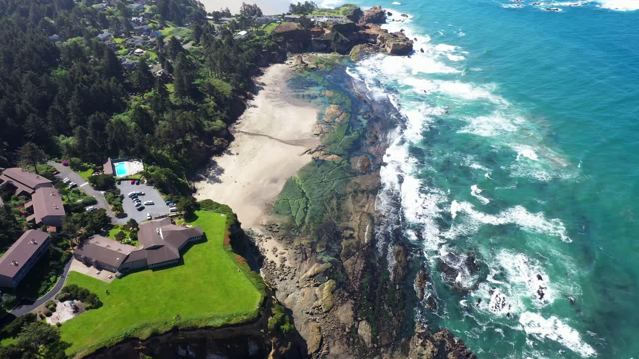 High aerial scenic view of ocean waves and rocky beach on the shores of California.