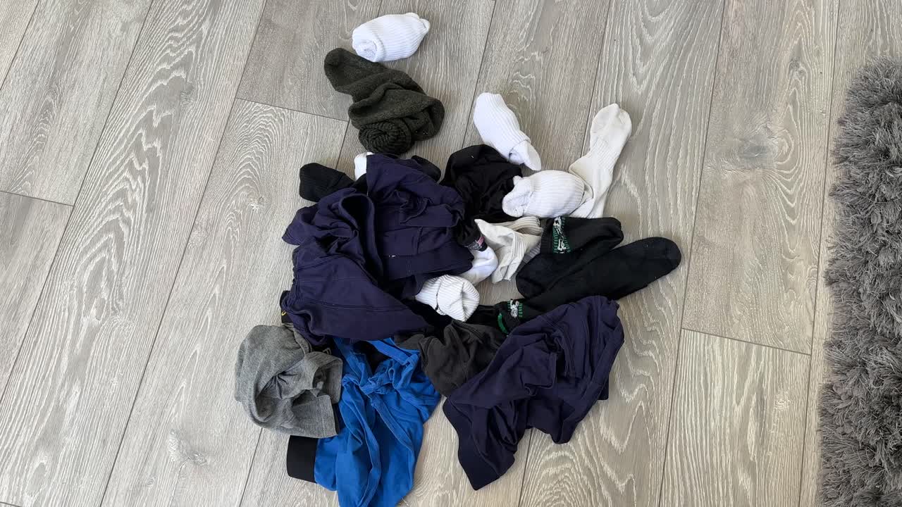 Pile of dirty pair of socks underwear boxer shorts on the bedroom floor washing laundry
