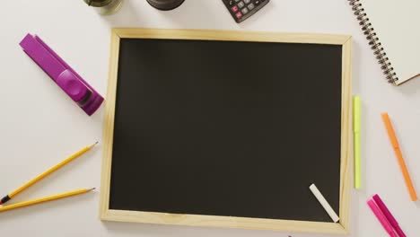 video of blackboard with copy space and school items on white background