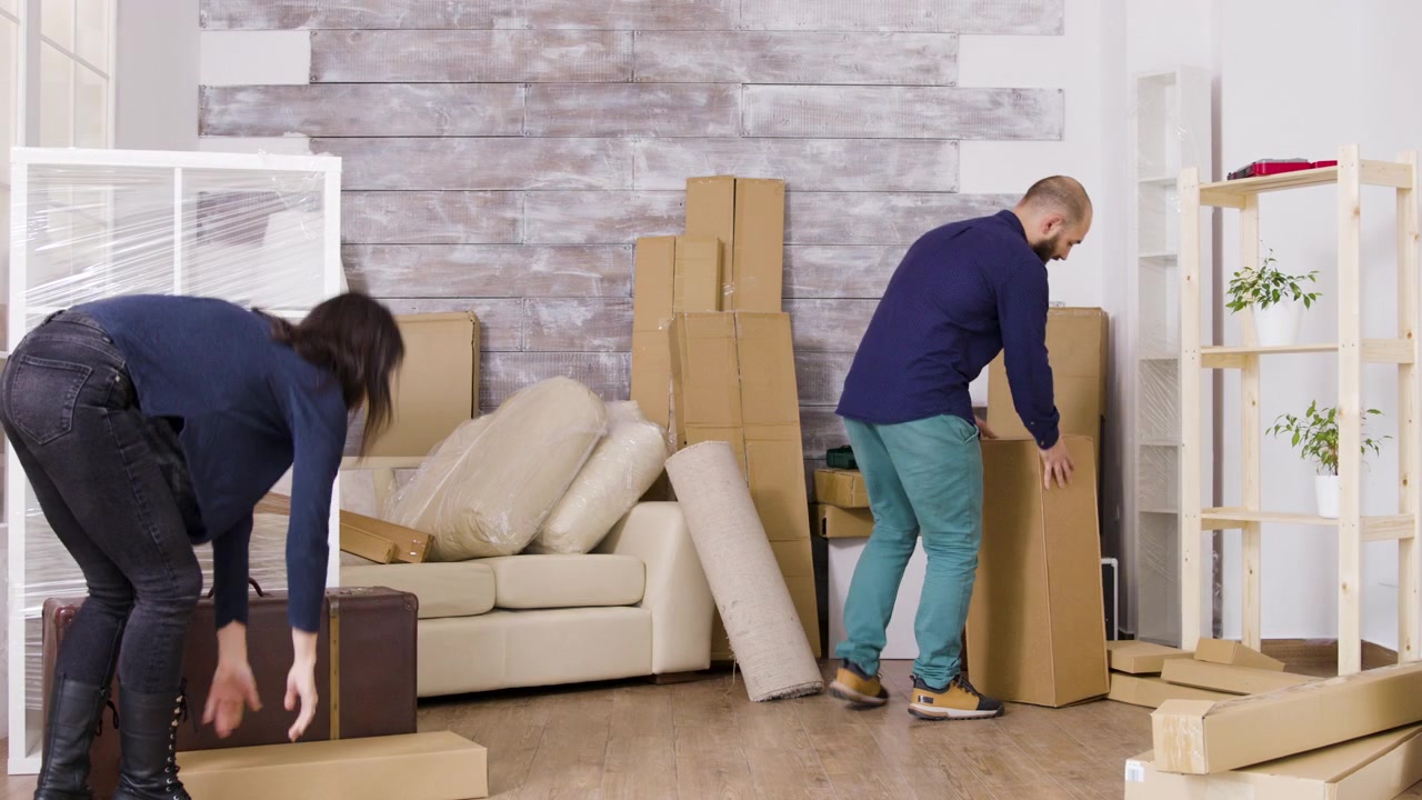 Couple Unpacking Cardboard Boxes in Their New Home