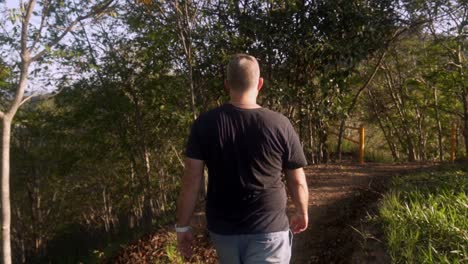 man walking along walking trail.