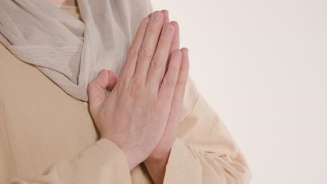 Close-Up-Shot-Of-Hands-Of-Man-Wearing-Robes-Representing-Figure-Of-Jesus-Christ-Praying-