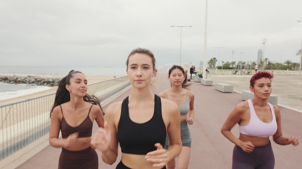 Four Women Running on Beach Path